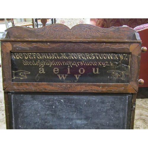 2338 - A late 19th century American child's folding easel enclosing a blackboard, the upper panel showing a... 