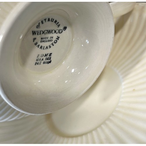 1140 - A collection of Wedgwood cream ground tableware comprising tea cups, saucers, open soup bowls, etc