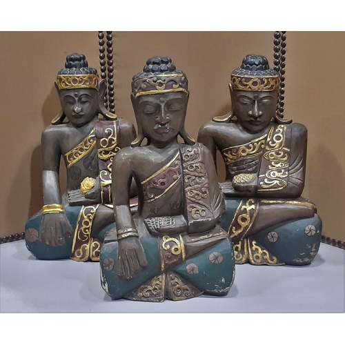Three carved timber Buddhist figures with painted finish, 63cm high