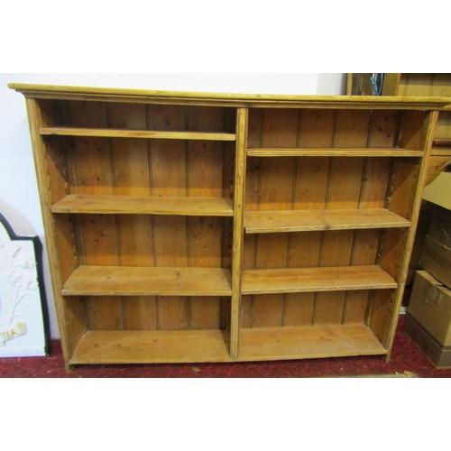 2117 - A stripped pine two divisional floorstanding open bookcase with adjustable shelves 161cm w x27cm d x... 