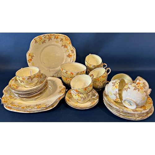 1136 - A Crown Staffordshire lemon ground tea set with printed floral detail