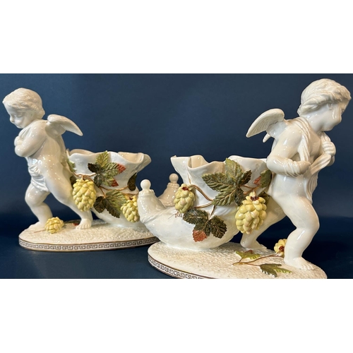 1147 - A pair of 19th century cornucopia Moore in the form of cherubs, the horns surrounded by flowering ho... 