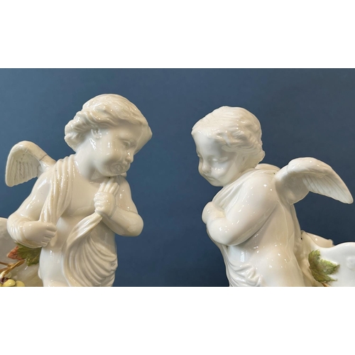 1147 - A pair of 19th century cornucopia Moore in the form of cherubs, the horns surrounded by flowering ho... 