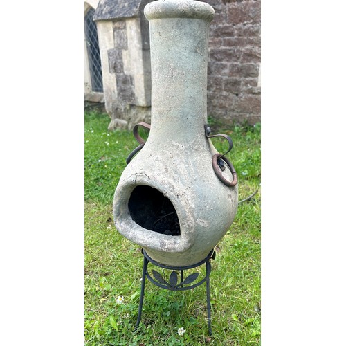 2082 - An unusually small weathered clay chimenea and stand, 70 cm high