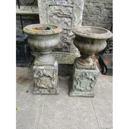 2058 - A pair weathered cast composition stone garden urns with circular lobed bowls and fixed socles, rais... 