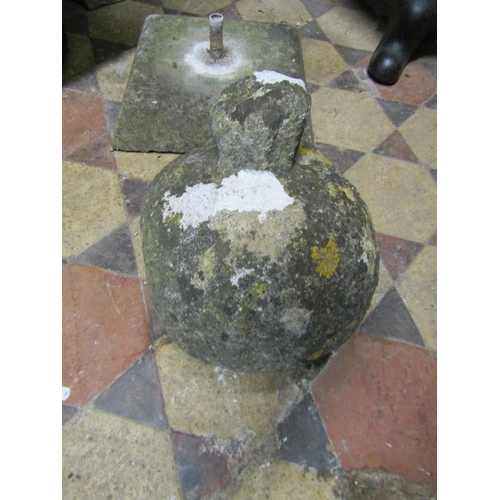 2083A - A weathered natural carved stone finial raised on a square tapered cap, 32 cm high