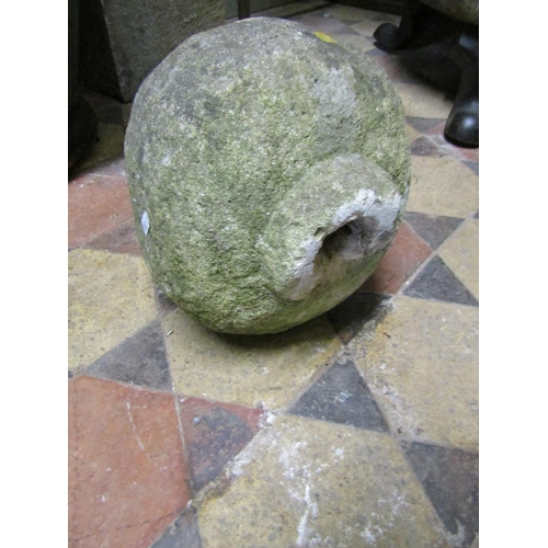 2083A - A weathered natural carved stone finial raised on a square tapered cap, 32 cm high