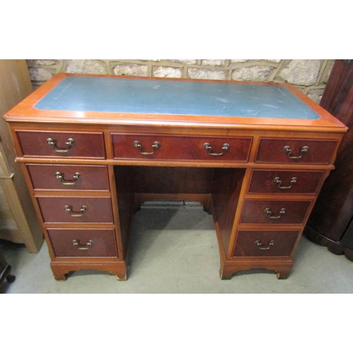 A reproduction kneehole twin pedestal desk fitted with eight frieze drawers disguised as nine on bracket supports (1 piece) 110cm x 54cm