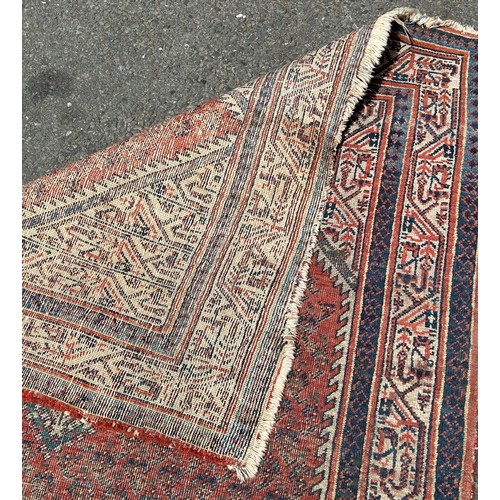 1677 - A Faded and Worn Old Persian Rug with central lozenge shaped panel and boteh design, 153 x 110 cm