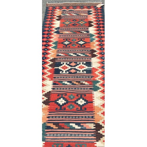 1679 - A Kilim Runner in natural multicoloured tones with a central panel of repeating shapes, hand-woven i... 