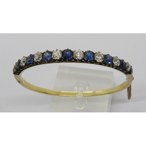 1392 - Fine early 20th century old cut sapphire and diamond hinged bangle, set with nine sapphires and eigh...