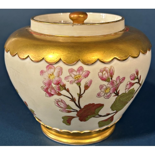 1091 - A Worcester porcelain oviform jar and cover with hand painted floral spray detail within gilded bord... 