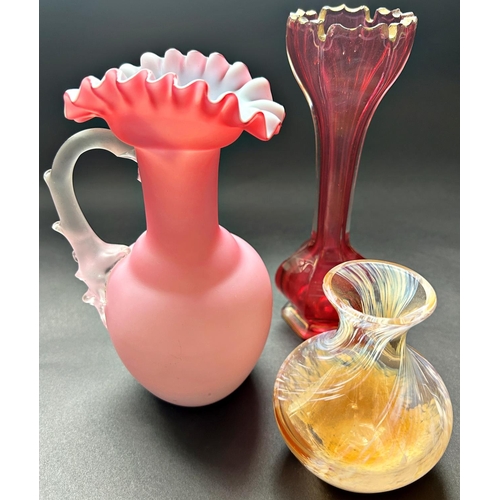 1187 - A mixed selection of glassware comprising a pink crimped jug, a bohemian red crenulated vase, pair o... 