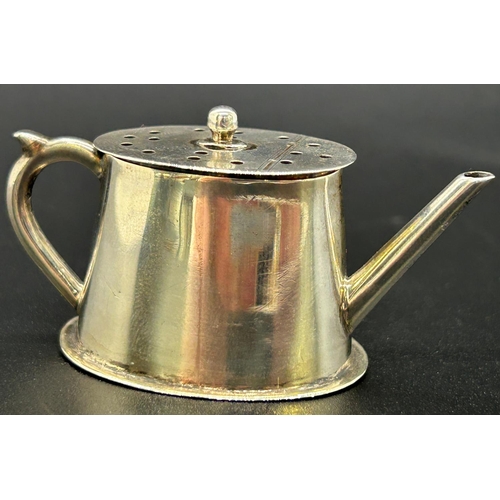 An attractive miniature novelty silver pepperette in the form of a teapot, Chester 1896, maker Saunders & Shepherd, weight 0.4oz approx