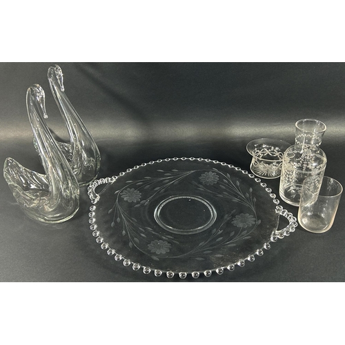 1172 - A large circular floral engraved fruit platter with handles, 37cm diameter, a pair of glass swans wi... 