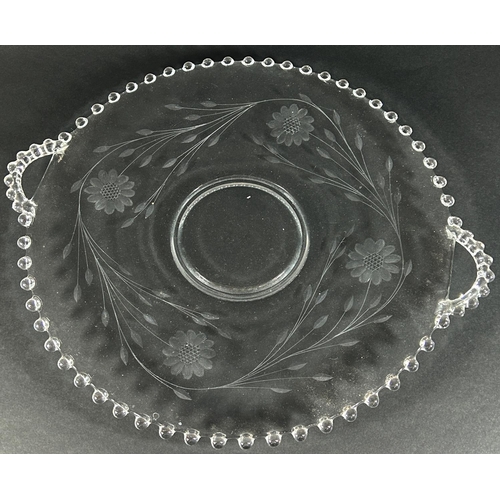 1172 - A large circular floral engraved fruit platter with handles, 37cm diameter, a pair of glass swans wi... 