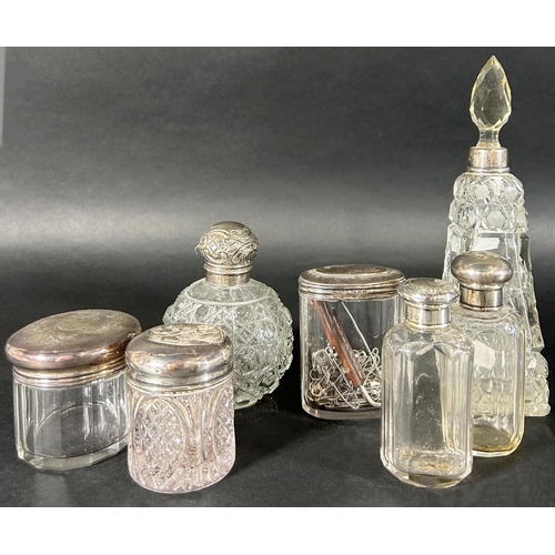 1180 - Seven cut glass dressing table jars and bottles, each with a silver lid or collar