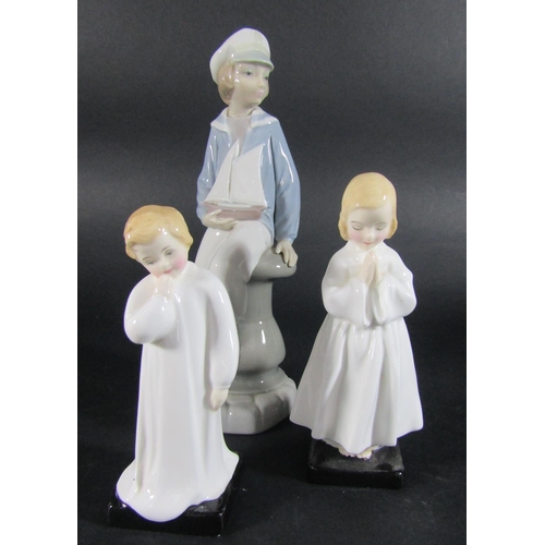Two Royal Doulton figures, Bedtime Prayers and Darling and a further Lladro figure of a boy with a boat