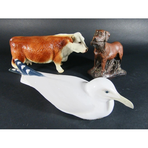 1075 - A Copenhagen model of a seagull together with a Hereford cow and a model of a Labrador with game