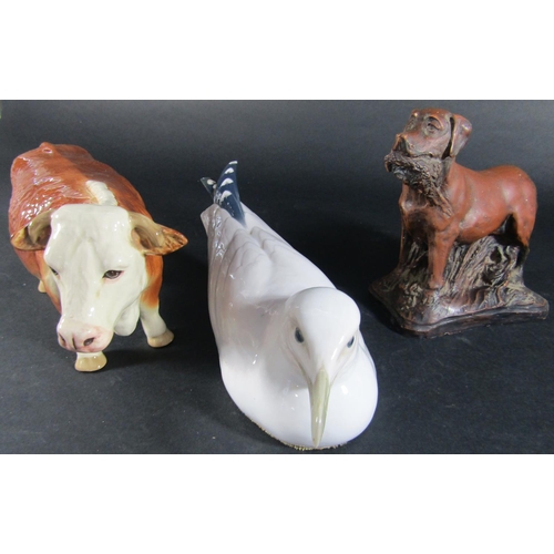 1075 - A Copenhagen model of a seagull together with a Hereford cow and a model of a Labrador with game