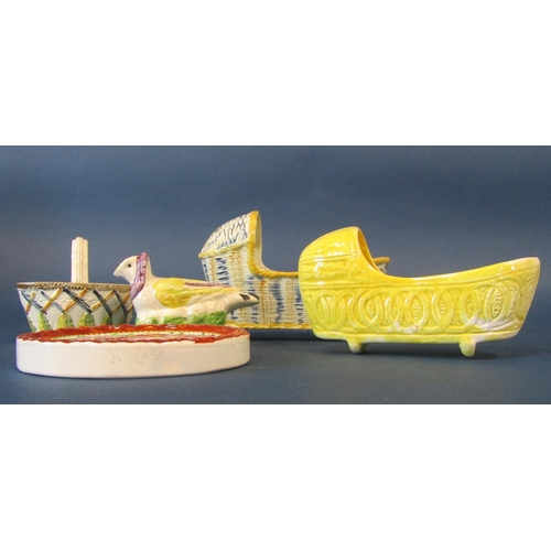 1082 - A Prattware cradle with simulated wicker design, a further smaller example with ochre glazed finish,... 