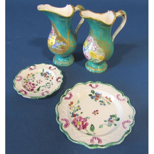 1084 - A pair of early 19th century ewers with turquoise glaze and hand painted floral reserves with scroll... 