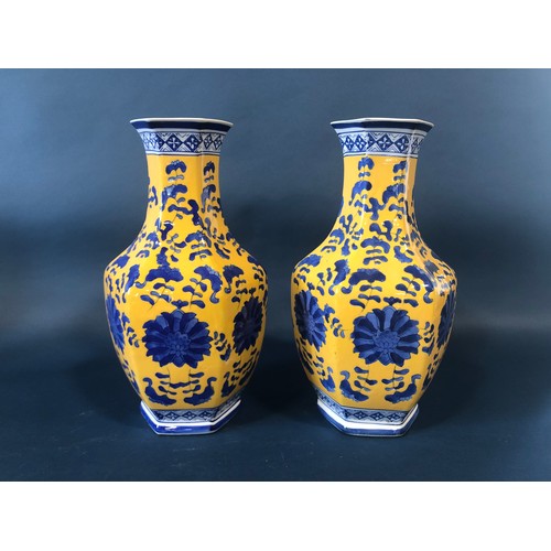 1062 - A collection of Chinese porcelain including a pair of hexagonal vases with drawn necks with blue flo... 