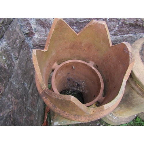 2061 - A weathered buff coloured cannon barrel chimney pot, 78cm high, together with two further crown top ... 