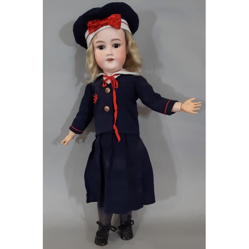 Early 20th century German bisque head doll by Armand Marseille, with closing brown eyes, open mouth with teeth and jointed composition body. Doll is wearing a navy sailor suit with matching hat, plus shoes, socks and period lace trimmed knickerbockers.  Impressed marks include '390 A9M', height 65cm.