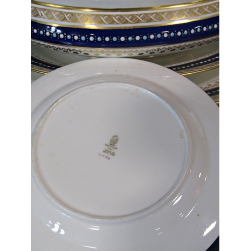 1133 - A quantity of Wedgwood dinner ware with a repeating blue and gilt banded colourway comprising meat p... 