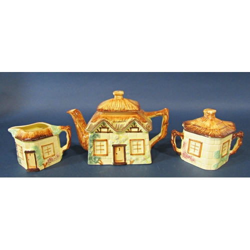 1134 - A Keele St pottery three piece tea set of cottage form, two cobalt blue bottles, Wedgewood Jasper wa... 