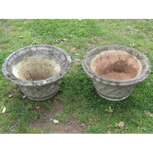 2003 - A pair of weathered cast composition stone circular flared garden urns, with lattice detail, 48cm di... 