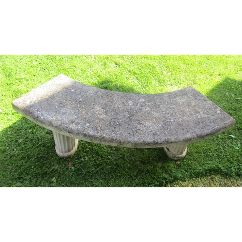 2060 - A weathered three sectional cast composition stone garden bench with crescent shaped slab seat, rais... 