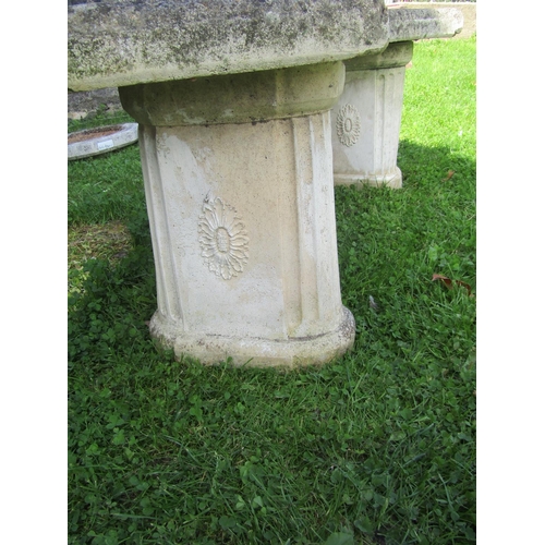 2060 - A weathered three sectional cast composition stone garden bench with crescent shaped slab seat, rais... 