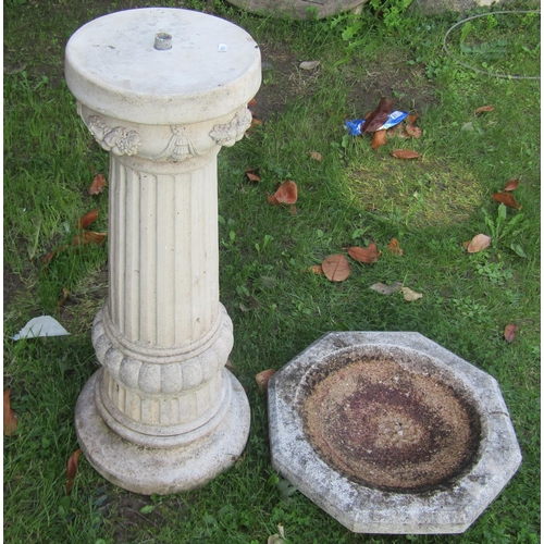 2062 - A weathered two sectional cast composition stone bird bath with octagonal top, raised on a fluted pe... 