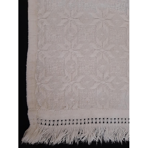 1830 - A pair of vintage cream fringed single bedspreads in patterned weave 150x230cm excl fringe, curved a... 