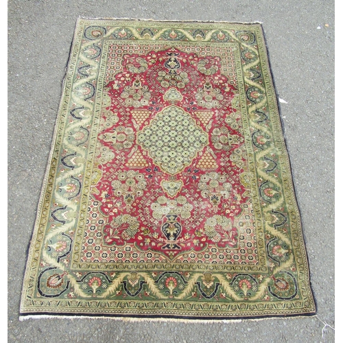 2744 - A Persian hand-knotted wool rug with vases of flowers and a scrolling floral border, in tones of cri... 