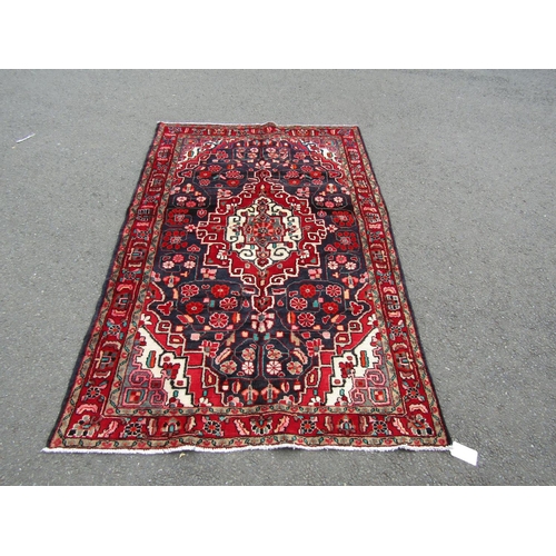 2745 - A North-west Persian Sarouk Rug, with an overall floral design predominantly in blue and red with ar... 