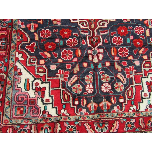 2745 - A North-west Persian Sarouk Rug, with an overall floral design predominantly in blue and red with ar... 