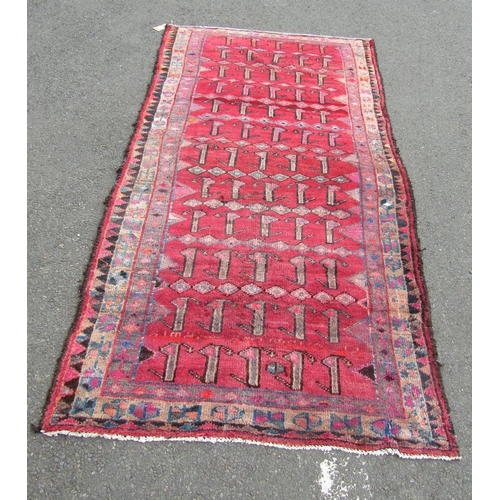 2749 - A Persian rug with multiple rows of stylised animals in red, pink and brown tones, 280 x 138 cm