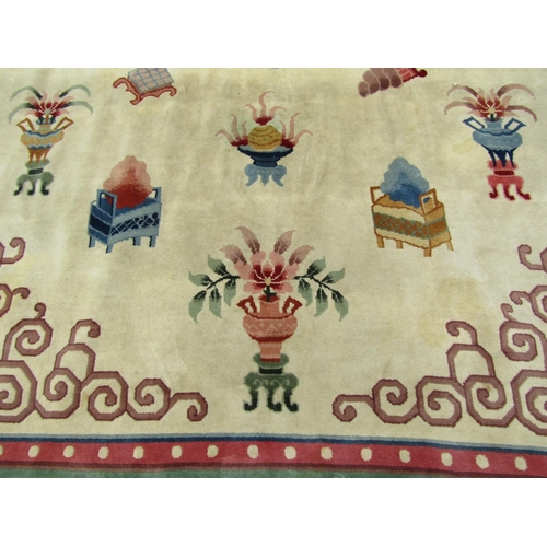 2752 - A large Chinese rug with central dragon medallion and motifs of lotus flowers, censers, urns and scr... 