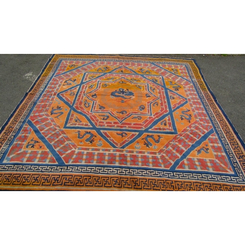 2754 - A Sino-Tibetan Dragon rug with eight-point star and swastika-patterned border in tones of yellow, bl... 