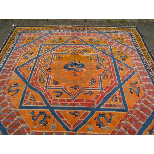 2754 - A Sino-Tibetan Dragon rug with eight-point star and swastika-patterned border in tones of yellow, bl... 