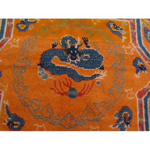 2754 - A Sino-Tibetan Dragon rug with eight-point star and swastika-patterned border in tones of yellow, bl... 