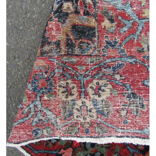 2756 - A Persian rug with all-over floral design, visible areas of repair and restitching, in dark blue and... 