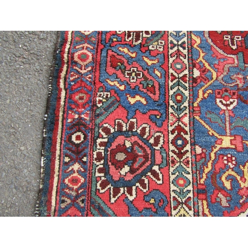 2758 - An old Persian Bakhtiar rug with a central floral medallion and traditional tones, 280 x 210 cm