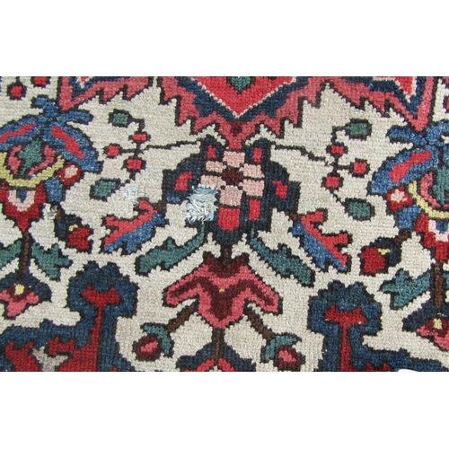 2758 - An old Persian Bakhtiar rug with a central floral medallion and traditional tones, 280 x 210 cm