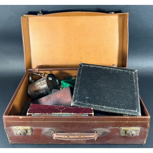 1222 - A vintage suitcase containing loose silver plated flatware, a cased set of fish knives and forks, a ... 