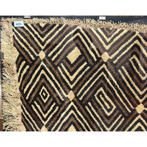 2755 - A West-African mud cloth, clip-framed behind perspex and mounted on board, 80 x 70 cm