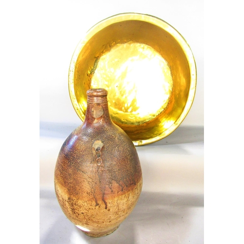 A salt bellarmine jar lacking handle and cracked, 46 cm tall and a brass circular basin, 50 cm diameter